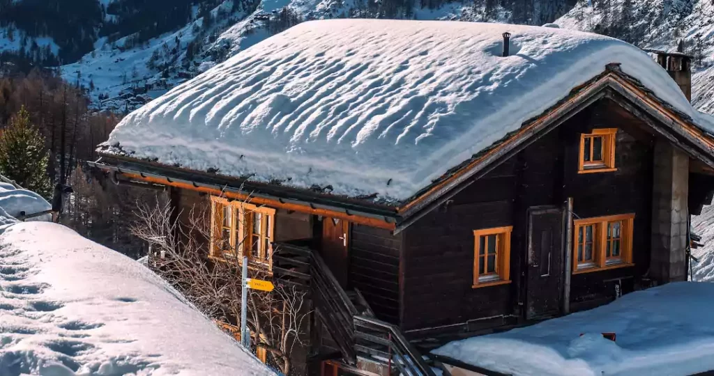  House with heavy snow on the roof in a harsh climate